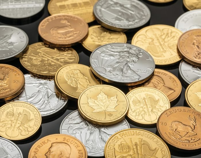 A detailed view of various gold and silver coins, ideal for financial themes.